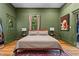 Bedroom with green walls, matching nightstands, and a rustic Oriental rug at 261 Ormond Se St, Atlanta, GA 30315