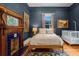 Cozy bedroom features a decorative fireplace, wood floors, and neutral toned walls at 261 Ormond Se St, Atlanta, GA 30315
