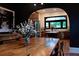 Dining area with wood table and a view through an arched doorway to a bright kitchen with an island at 261 Ormond Se St, Atlanta, GA 30315
