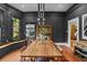 Elegant dining room featuring a long wooden table, hardwood floors, and a large window with natural light at 261 Ormond Se St, Atlanta, GA 30315