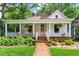 Charming home with a brick pathway, lush landscaping, and a welcoming front porch at 261 Ormond Se St, Atlanta, GA 30315