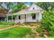 Charming home featuring a welcoming front porch and beautifully landscaped front yard at 261 Ormond Se St, Atlanta, GA 30315