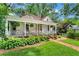 Inviting home showcasing a classic front porch, brick pathway, and lush landscaping at 261 Ormond Se St, Atlanta, GA 30315