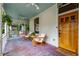 Relaxing front porch with chairs, swing, and stylish wood door at 261 Ormond Se St, Atlanta, GA 30315