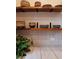 Kitchen counter and open wood shelves, along with a green plant, marble counters and unique back splash at 261 Ormond Se St, Atlanta, GA 30315