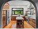 Gourmet kitchen with stainless steel appliances, custom wood cabinetry, island, and updated lighting at 261 Ormond Se St, Atlanta, GA 30315