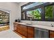 Gourmet kitchen with black framed windows, stainless steel appliances, and custom wood cabinets at 261 Ormond Se St, Atlanta, GA 30315