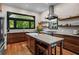 Bright kitchen featuring custom wood cabinets, stainless steel appliances, and an island with seating at 261 Ormond Se St, Atlanta, GA 30315