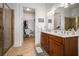 Primary bathroom with dual sinks, tile floor, shower, and walk in closet at 326 Roswell Se St # 706, Marietta, GA 30060