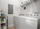 Modern laundry room featuring a side-by-side washer and dryer, plus shelving for storage at 326 Roswell Se St # 706, Marietta, GA 30060