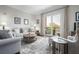 Comfortable living room with cozy seating, soft lighting, and a balcony offering outdoor views for relaxation at 326 Roswell Se St # 706, Marietta, GA 30060