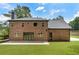 Spacious backyard featuring a brick home with ample windows and a lush green lawn at 3711 Mountain Cove Rd, Snellville, GA 30039