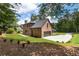 Large backyard features a well-manicured lawn and brick home with a three car garage at 3711 Mountain Cove Rd, Snellville, GA 30039