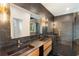 Bathroom with black marble tile, dual vanity, gold fixtures, and walk-in shower at 3711 Mountain Cove Rd, Snellville, GA 30039