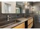 Sleek bathroom featuring a double sink vanity with modern fixtures and black marble countertops at 3711 Mountain Cove Rd, Snellville, GA 30039