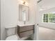 Modern bathroom with grey floating vanity and sink, with view to bedroom at 3711 Mountain Cove Rd, Snellville, GA 30039