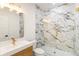 Gorgeous bathroom with marble tile, sleek fixtures, and a glass-enclosed shower at 3711 Mountain Cove Rd, Snellville, GA 30039