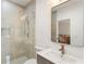 Modern bathroom with walk-in shower, custom vanity and gold fixtures at 3711 Mountain Cove Rd, Snellville, GA 30039
