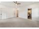 Spacious bedroom with neutral carpet, ceiling fan, and an ensuite bathroom at 3711 Mountain Cove Rd, Snellville, GA 30039