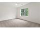 Bright bedroom with soft carpet and window with outdoor views at 3711 Mountain Cove Rd, Snellville, GA 30039