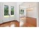 Bright dining room with gleaming hardwood floors and modern chandelier at 3711 Mountain Cove Rd, Snellville, GA 30039