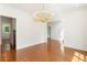 Dining room with gleaming hardwood floors, a modern chandelier, and white walls at 3711 Mountain Cove Rd, Snellville, GA 30039