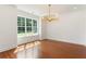 Dining room with hardwood flooring and a modern chandelier at 3711 Mountain Cove Rd, Snellville, GA 30039