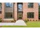 Inviting entryway into a modern brick home with an open floor plan and manicured landscaping at 3711 Mountain Cove Rd, Snellville, GA 30039
