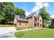 Charming brick home with a side-entry garage, manicured landscaping, and a spacious front lawn at 3711 Mountain Cove Rd, Snellville, GA 30039