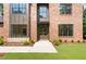 Two-story brick home with black trim windows and a covered front entrance at 3711 Mountain Cove Rd, Snellville, GA 30039