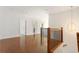 Spacious upstairs hallway with hardwood floors, white walls, and a modern light fixture at 3711 Mountain Cove Rd, Snellville, GA 30039