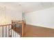 Spacious hallway with wood floors, wood handrail, and modern chandelier at 3711 Mountain Cove Rd, Snellville, GA 30039
