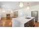 Gourmet kitchen boasts an island with seating, stainless appliances, and adjacent living room at 3711 Mountain Cove Rd, Snellville, GA 30039