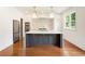 Modern kitchen features an island with seating, stainless appliances, and custom cabinetry at 3711 Mountain Cove Rd, Snellville, GA 30039