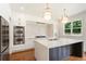 Modern kitchen features an island with seating, stainless appliances, and a large window at 3711 Mountain Cove Rd, Snellville, GA 30039