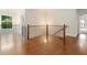 Bright landing with hardwood floors, black railings, and views of trees from windows at 3711 Mountain Cove Rd, Snellville, GA 30039