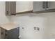 Laundry room features gray cabinets, white countertops, and hardware connections ready for appliances at 3711 Mountain Cove Rd, Snellville, GA 30039