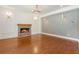Spacious living room features hardwood floors, a stone fireplace, recessed lighting, and modern sconces at 3711 Mountain Cove Rd, Snellville, GA 30039