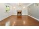 Open concept living room features a stone fireplace, hardwood floors, and modern light fixtures at 3711 Mountain Cove Rd, Snellville, GA 30039