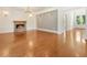 Bright living room featuring hardwood floors, a stone fireplace, and stylish wall sconces at 3711 Mountain Cove Rd, Snellville, GA 30039