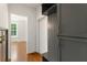 Mudroom features a gray cabinet with hooks and bench adjacent to a doorway with wood floors at 3711 Mountain Cove Rd, Snellville, GA 30039