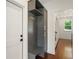 Mudroom features gray built-in shelving with hooks and bench next to a white door at 3711 Mountain Cove Rd, Snellville, GA 30039