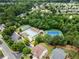 An aerial view shows a community pool, tennis courts, and basketball court surrounded by lush greenery in a well-maintained neighborhood at 5420 Stevehaven Ln, Cumming, GA 30028