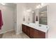 Bathroom featuring double sinks, wooden cabinets, tile flooring, and a separate shower at 5420 Stevehaven Ln, Cumming, GA 30028