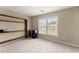 Neutral bedroom with built-in shelving and large window at 5420 Stevehaven Ln, Cumming, GA 30028