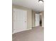 Neutral bedroom showcasing the door and carpet flooring at 5420 Stevehaven Ln, Cumming, GA 30028