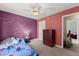 Themed bedroom featuring painted walls, a dresser, and a comfortable carpeted floor at 5420 Stevehaven Ln, Cumming, GA 30028