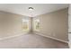 Bright bedroom with a neutral color palette, large windows, and carpeted flooring at 5420 Stevehaven Ln, Cumming, GA 30028