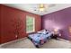 Charming bedroom with themed painted walls and a window, creating a playful atmosphere at 5420 Stevehaven Ln, Cumming, GA 30028