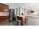 Open kitchen featuring an island, stainless steel refrigerator, and access to the living area at 5420 Stevehaven Ln, Cumming, GA 30028